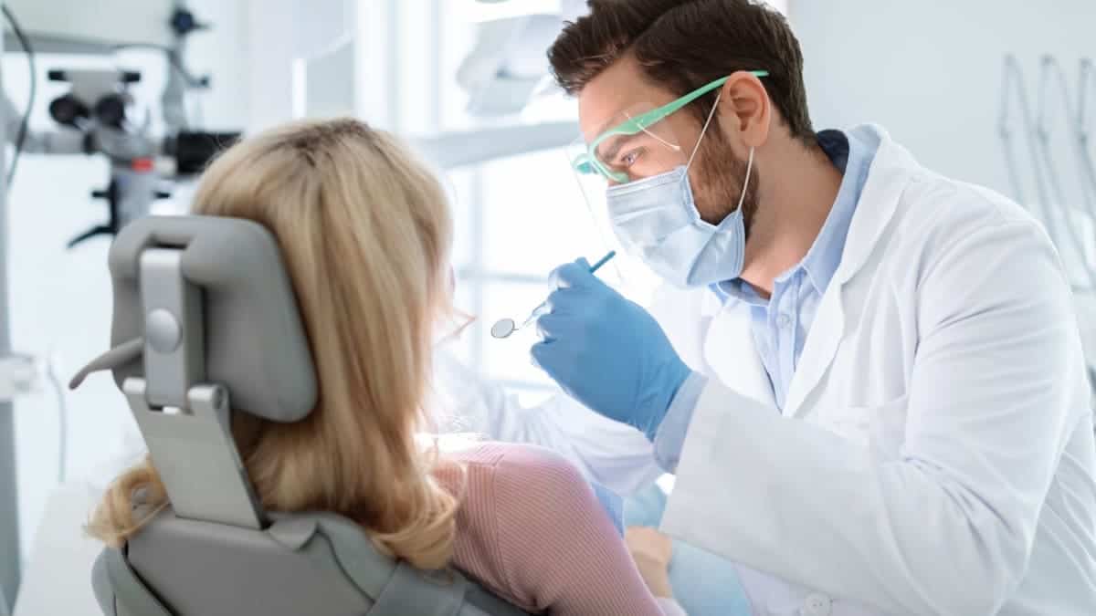 Patient receiving professional teeth whitening with a laser device West Bromwich